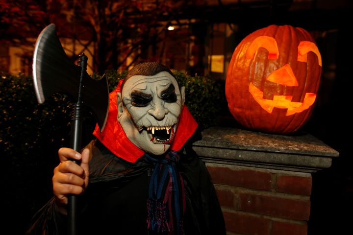 Teenager playing trick or treat in London on Halloween night, UK