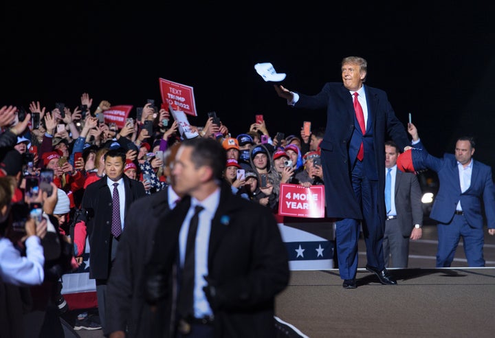 Trump tosses a cap to supporters in Duluth, Minnesota, on Wednesday. 