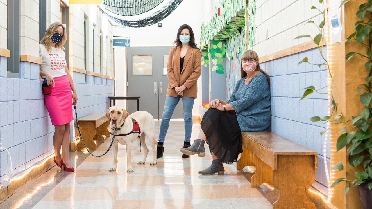 From left, program director Erin Sibley Doerwald, office manager Marisol Peña and executive director Apryl Miller in the hallway with Otis the therapy dog at the Sky Center in Santa Fe, New Mexico.