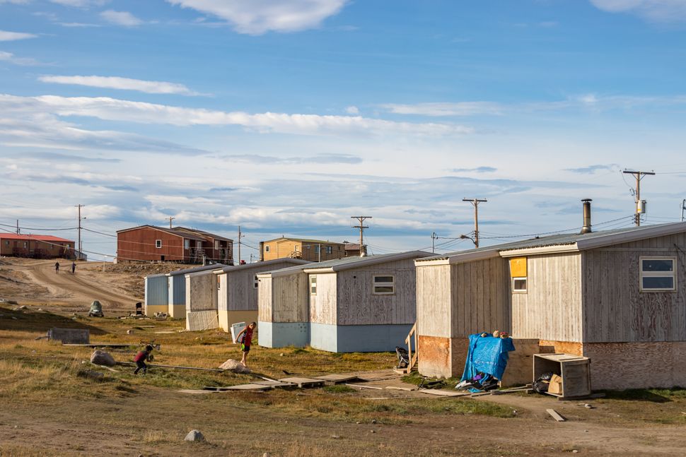File photo of residential wooden houses on a dirt road in Pond Inlet, Baffin Island on Aug. 23, 2019.