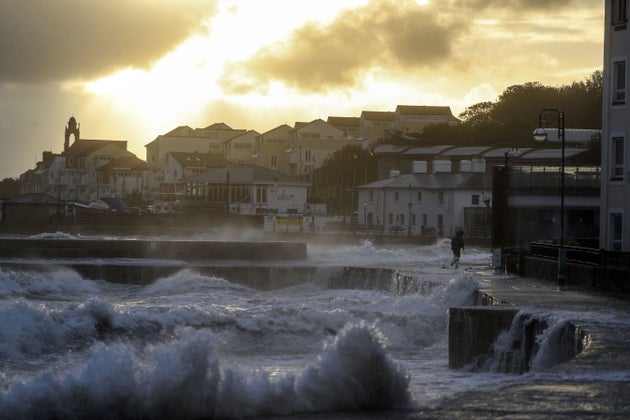 Waves crash against the sea wall in Swanage, Dorset. 