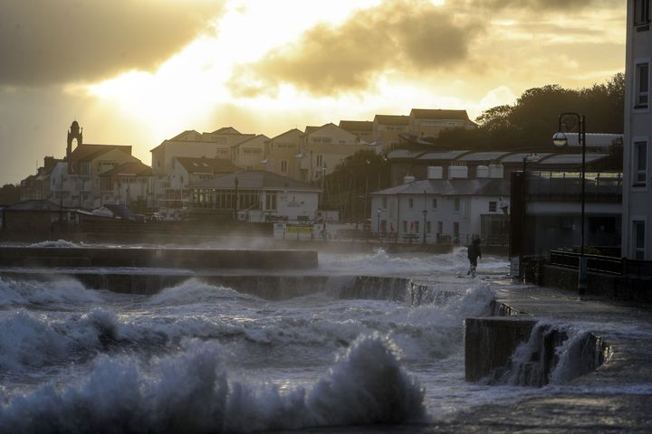 Waves crash against the sea wall in Swanage, Dorset. 