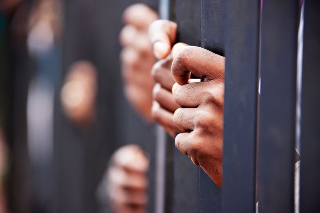 Stolen life, group of hands African people behind bars holding