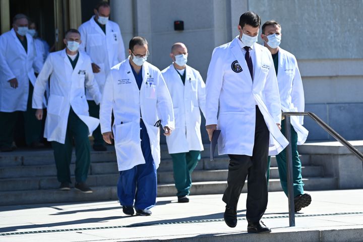 White House physician Sean Conley (2nd R), with medical staff, arrives to give an update on the condition of Donald Trump.