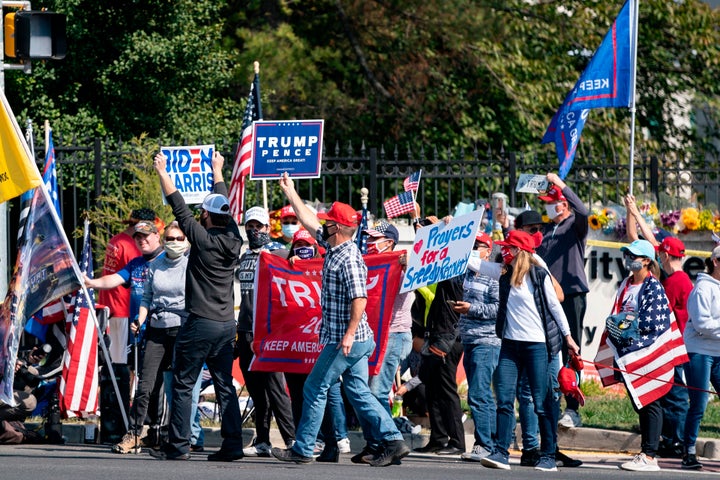 A a group consisting largely of Trump supporters gathers outside Walter Reed National Military Medical Center in Maryland on Sunday.