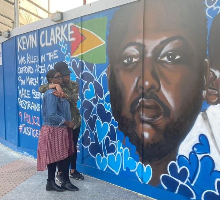 Wendy Clarke, Kevin's mother, and his sister Tellecia at a mural of Kevin in Lewisham