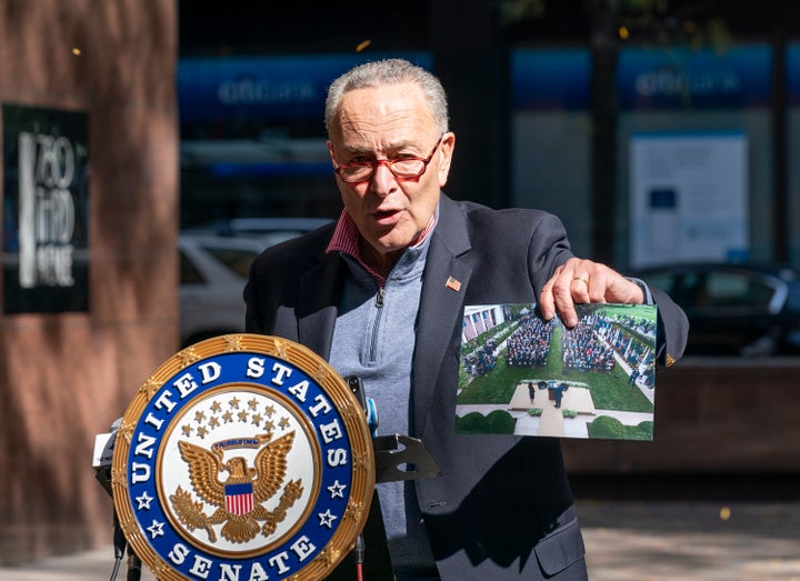 Senate Minority Leader Chuck Senator, speaking in New York City on Oct. 4, holds up a picture of the Rose Garden ceremony where the coronavirus likely spread.