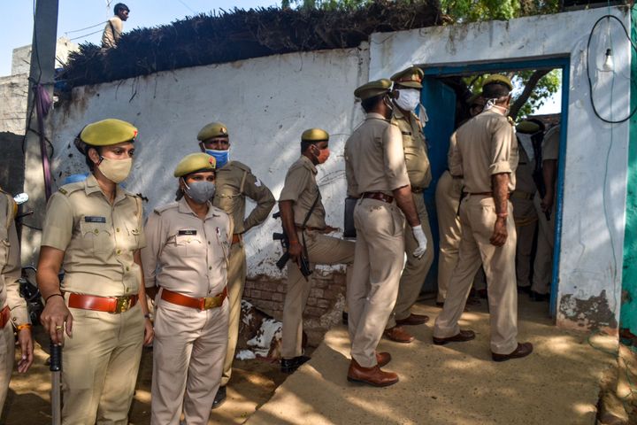 Police personnel near the house of the relatives of the 19-year-old woman in Bool Garhi of Hathras district in Uttar Pradesh state on October 3, 2020.