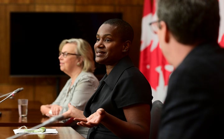 New Green Party Leader Annamie Paul, middle, holds a press conference alongside Green Party government house leader Elizabeth May, left, and Green MP Paul Manly in Ottawa on Oct. 5, 2020.