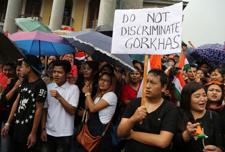 Protestors demanding the creation of separate state of Gorkhaland in India's north-east, stand in rain during a demonstration in Bangalore, India, Tuesday, June 20, 2017. 