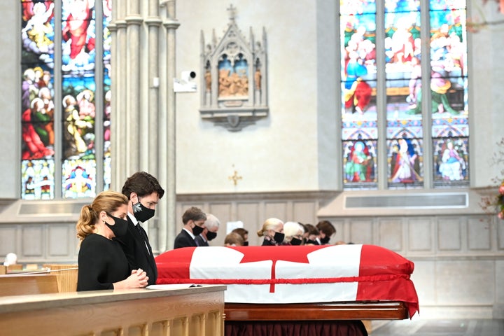 Prime Minister Justin Trudeau and wife Sophie Gregorie Trudeau kneel and pray during the state funeral service for former Canadian prime minister John Turner at St. Michael's Cathedral Basilica in Toronto on Tuesday, Oct. 6, 2020.