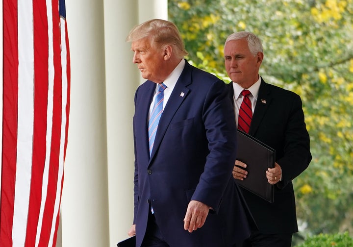 Donald Trump and Mike Pence arrive to speak on COVID-19 testing in the Rose Garden of the White House on Sept. 28, 2020. Trump tested positive on Oct. 1.