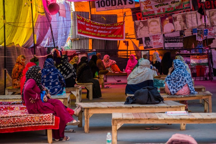 People sit at a distance as they continue their protest against CAA amid a lockdown order by Delhi's government as a preventive measure against the COVID-19 on March 23, 2020 in Shaheen Bagh.