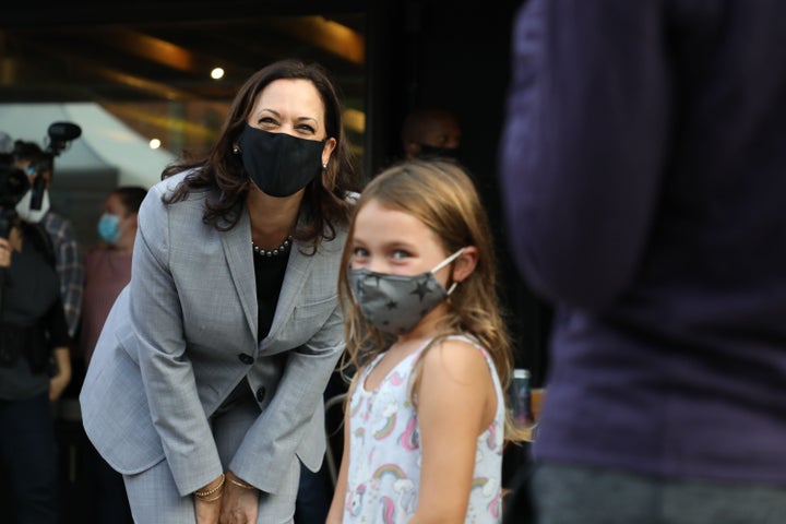 United States Senator and Democratic Vice Presidential nominee Kamala Harris greet and takes a picture with a child after greeting patrons of Trophy Brewing and Pizza at a planned campaign stop in Raleigh, North Carolina.