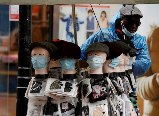 A street trader sells face masks from a stall in Manchester earlier this month.