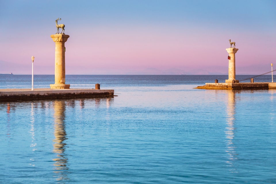 Famous tourist destination in Mandraki port with deers statue, where The Colossus was standing. Rhodes, Greece