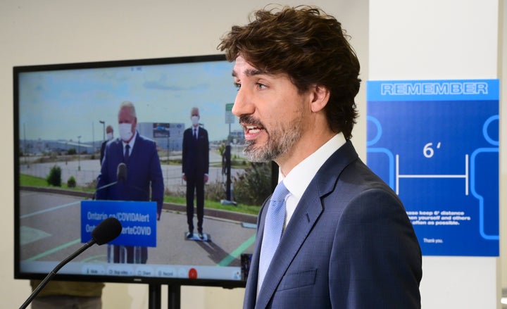 Prime Minister Justin Trudeau takes part in a press conference at the Ford Connectivity and Innovation Centre in Ottawa on Oct. 8 2020, as Ontario Premier Doug Ford is shown joining virtually. 