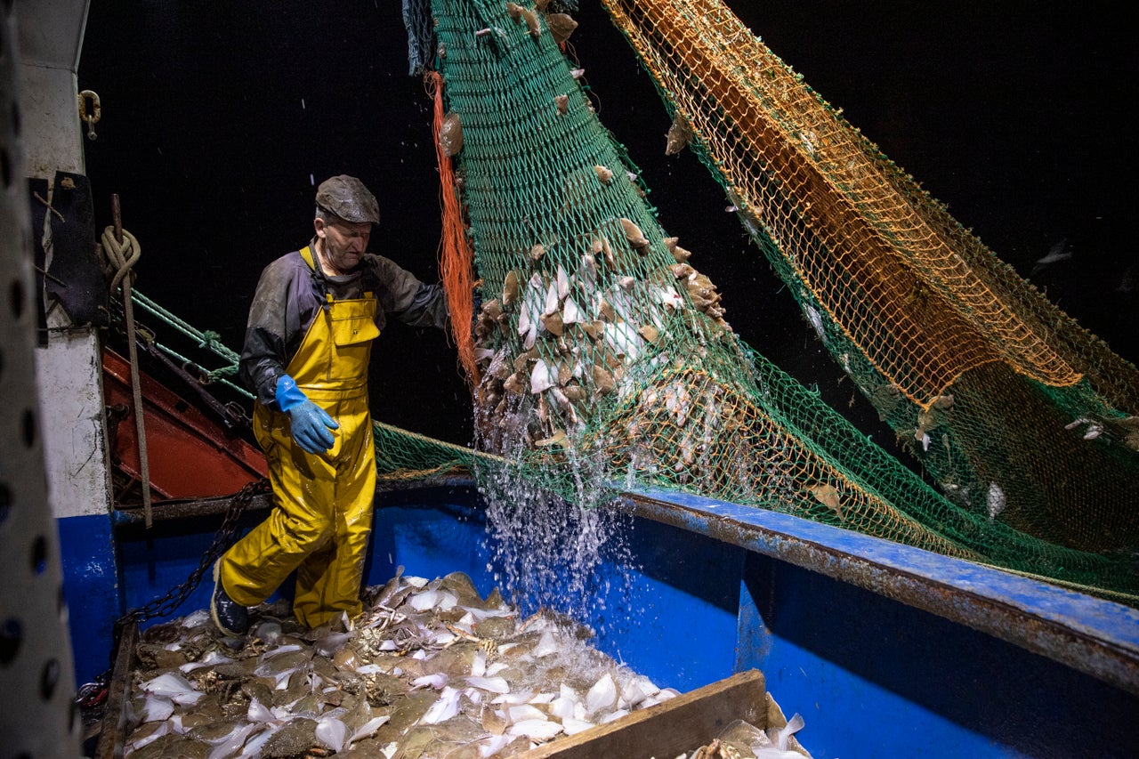 Fishermen work in the English Channel, off the coast of Hastings.