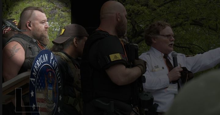 William Null, charged in a militia plot to kidnap Democratic Michigan Gov. Gretchen Whitmer, appears onstage alongside Barry County Sheriff Dar Leaf at an anti-lockdown rally on May 18, 2020, in Grand Rapids, Michigan.