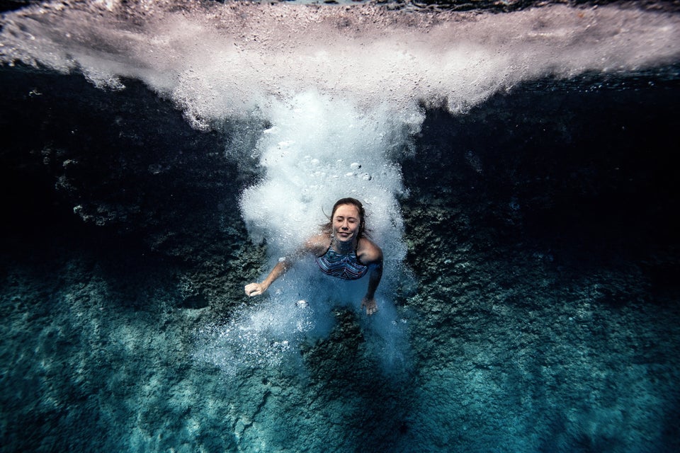 ANTALYA, TURKEY - OCTOBER 05: A woman dives into the clear water of "Suluada" (meaning"watery island") located 7 kilometers from another favorite spot location for deep water soloing Cape Gelidonya, in Antalya, Turkey on October 05, 2020. Deep water soloing, is a solo rock climbing, where rocks rising from the sea are climbed with no equipment except for climbing shoes and then dived into water. (Photo by Sebnem Coskun/Anadolu Agency via Getty Images)