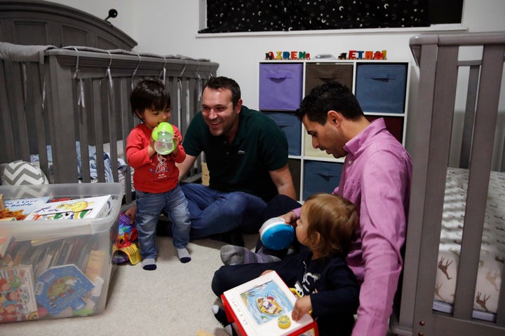 Andrew Dvash-Banks (right) and his husband, Elad, play with their twin sons, Ethan and Aiden.