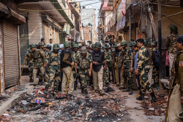 Indian paramilitary forces patrol in the majority community in a riot- affected area on February 28,...