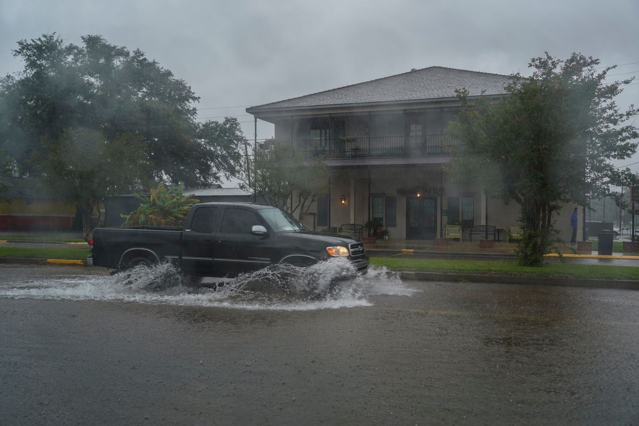 A pickup truck drives through flooded road as Hurricane Delta approaches in Lake Arthur, Louisiana. 