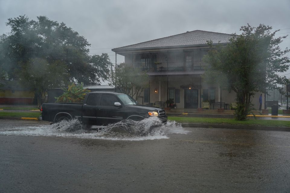 A pickup truck drives through flooded road as Hurricane Delta approaches in Lake Arthur, Louisiana. 