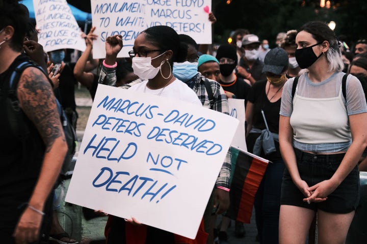 RICHMOND, VA - JULY 28: Protesters holding a sign that reads Marcus-David Peters Deserved HELP Not DEATH!! at a demonstratio