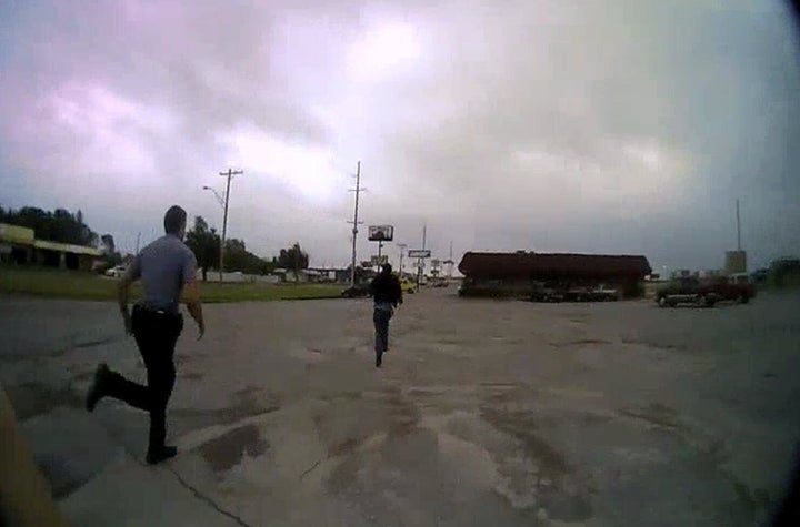 Police chase Derrick Scott before detaining him in Oklahoma City, Oklahoma, U.S., May 20, 2019 in this framegrab from police