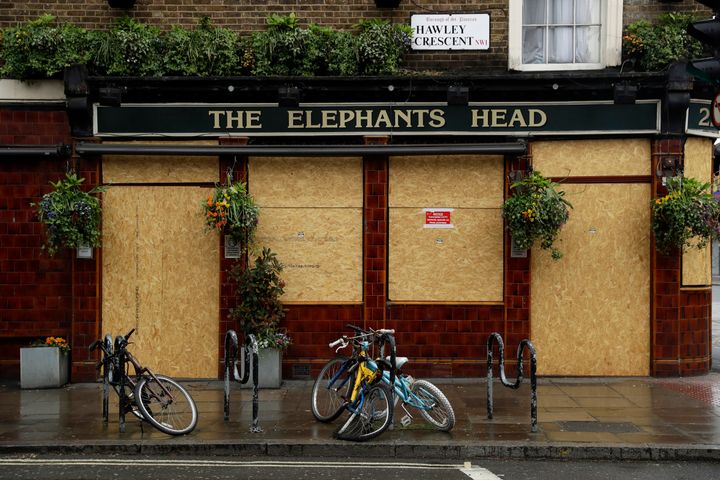 The Elephant's Head pub stands temporarily closed with boarding put up on the windows and doors due to the nationwide coronavirus lockdown in April.