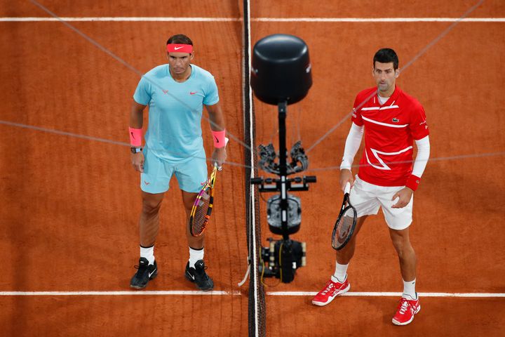 Serbia's Novak Djokovic, right, and Spain's Rafael Nadal are filmed by a remote camera as they pose for images prior to the final match of the French Open tennis tournament at the Roland Garros stadium in Paris, France, Sunday, Oct. 11, 2020. (AP Photo/Alessandra Tarantino)