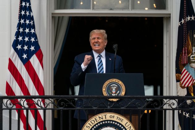 US President Donald Trump stands on the balcony of the White House and talks to his supporters.  2020