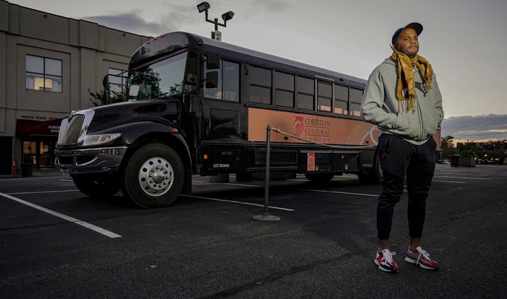 Keith White, director of social justice initiatives at Christian Cultural Center, stands next to a bus the church plans to update with COVID-19 protocols to transport people to the polls on Election Day, Friday, Sept. 18, 2020, in the Brooklyn borough of New York.