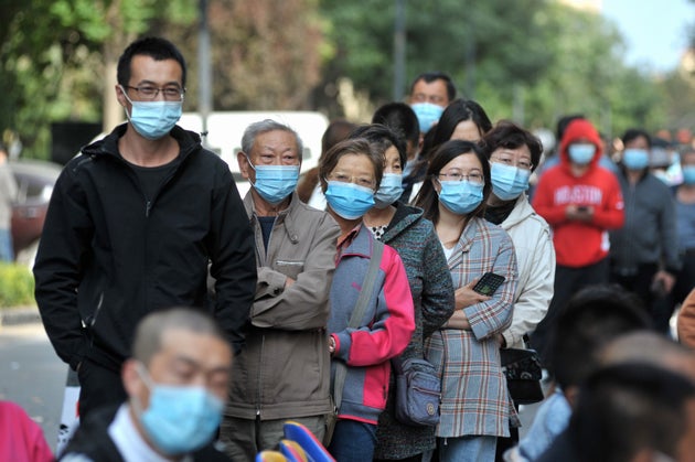 This photo taken on October 12, 2020 shows residents lining up to be tested for the COVID-19 coronavirus,...