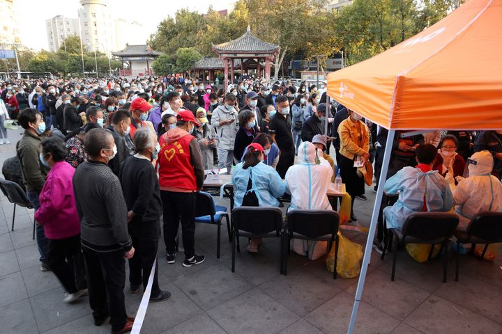 This photo taken on October 12, 2020 shows residents lining up to be tested for the COVID-19 coronavirus, as part of a mass testing program following a new coronavirus outbreak in Qingdao, in China's eastern Shandong province. (Photo by STR / AFP) / China OUT (Photo by STR/AFP via Getty Images)