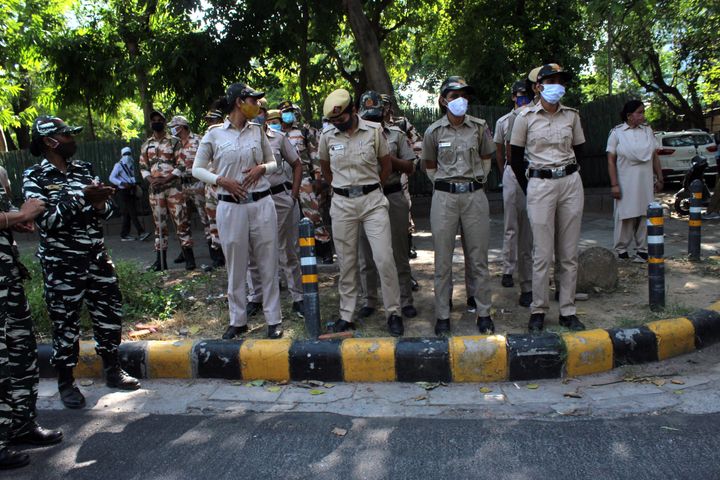 Security personnel are seen outside the Uttar Pradesh Bhawan during a demonstration in New Delhi on September 30, 2020, a day after a 19-year-old woman who was allegedly gang-raped died from her injuries in the Uttar Pradesh's Hathras. UP police is accused of forcibly cremating the body of a 19-year-old Dalit woman, who died in a Delhi hospital a fortnight after she was gangraped. (Photo by Mayank Makhija/NurPhoto via Getty Images)