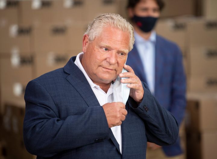 Ontario Premier Doug Ford removes his mask to speak to media in Brockville, Ont. on Aug. 21, 2020.