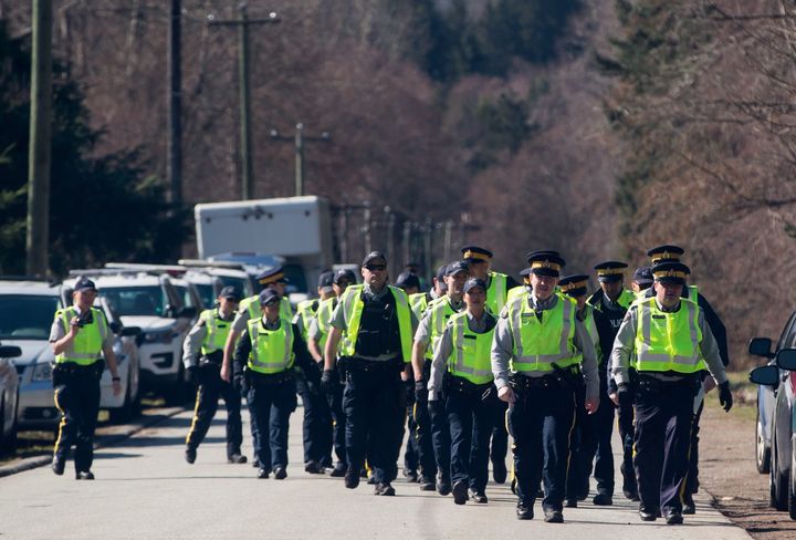 RCMP officers arrive to deal with protesters blocking a gate outside Kinder Morgan, in Burnaby, B.C., on March 17, 2018.