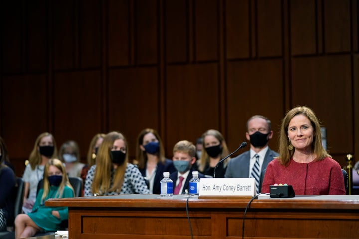 Barrett's husband sits behind her during Tuesday's committee hearing, along with some of the couple's seven children.