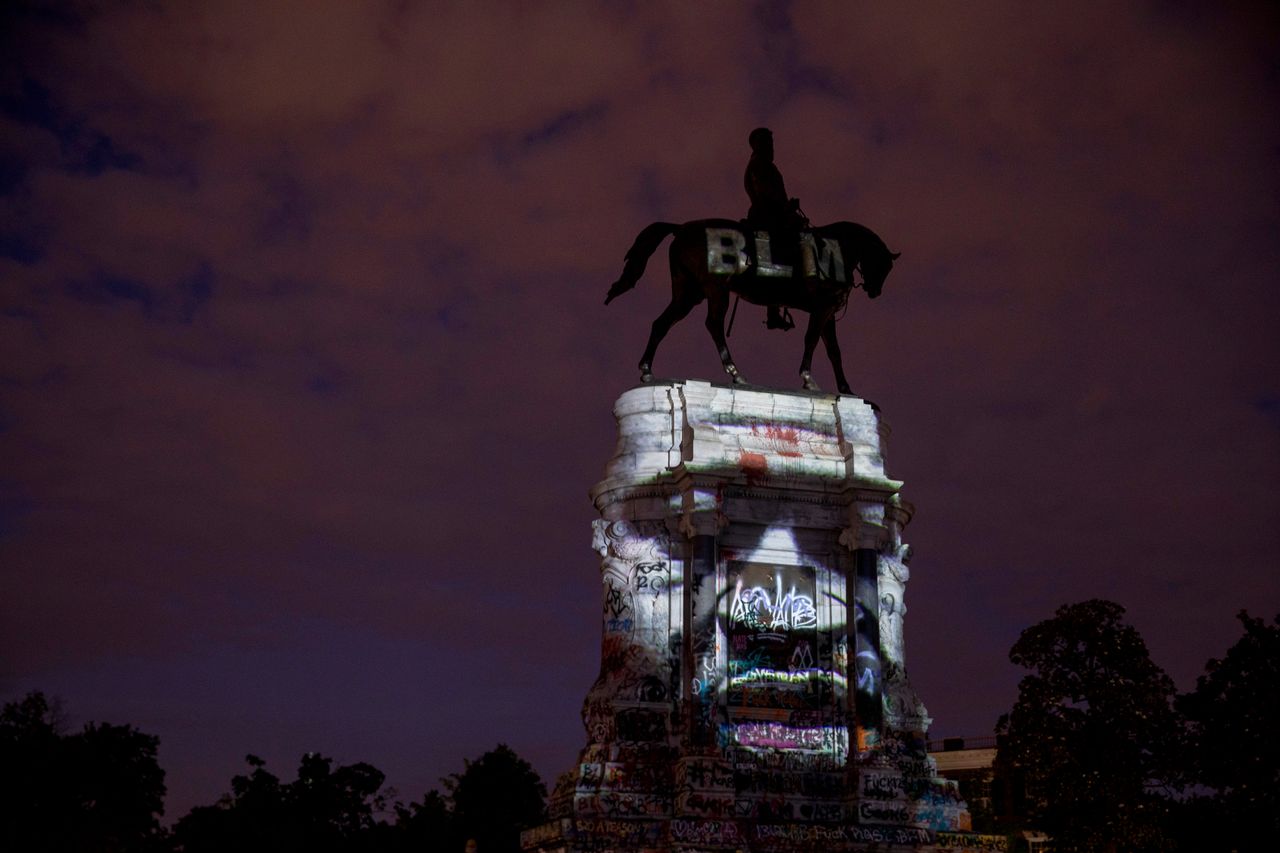 The image of George Floyd, a Black man who was killed at the hands of police earlier this year, is projected onto the Robert E. Lee Monument on June 18 in Richmond, Virginia. Richmond Circuit Court Judge Bradley Cavedo on Thursday ruled to indefinitely extend an injunction preventing the state governor from removing the historic statue of the Confederate general from Richmond's famed Monument Avenue.