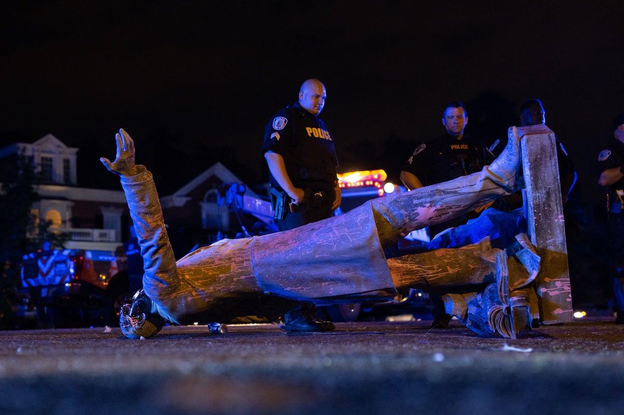 A statue of Confederate States President Jefferson Davis lies on the street after protesters pulled it down in Richmond, Virginia, on June 10. The symbols of the Confederate States and their support for slavery are being targeted for removal following Floyd's death.