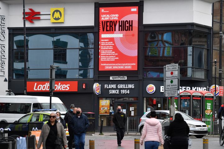 A coronavirus NHS billboard warns pedestrians at Liverpool central station in Liverpool, north west England on October 14, 2020, as new local lockdown measures come in to force to help stem a second wave of the novel coronavirus COVID-19. - The northwest city of Liverpool -- the only place put into the highest category --