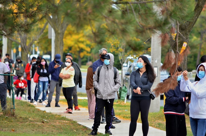 People wait in line for a Covid-19 test at the Birchmount Covid-19 Assessment Centre in Scarborough, Ontario on Sept. 29, 2020.