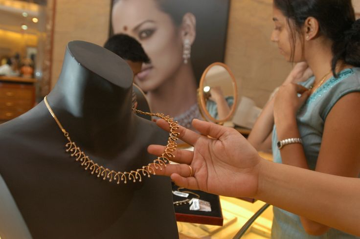Shoppers pick out jewelry from a Tanishq store in Bangalore, India.