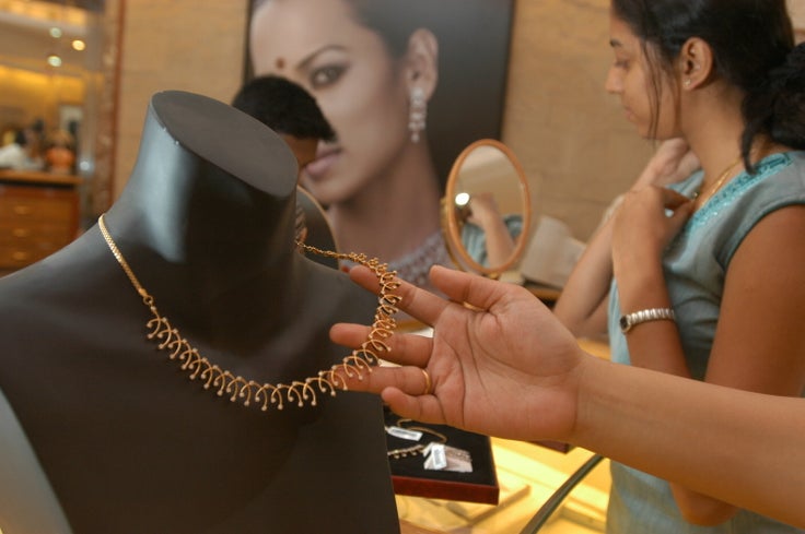 Shoppers pick out jewelry from a Tanishq store in Bangalore, India.