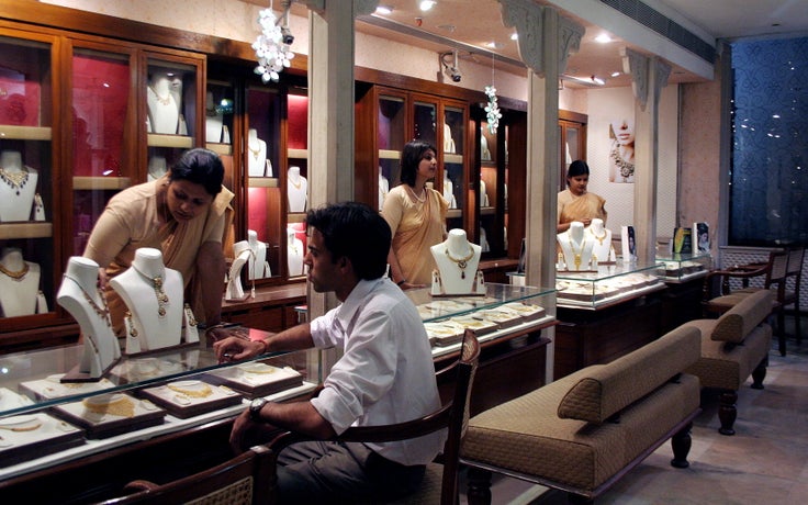 A man browses jewelry at a Tanishq showroom in Kolkata, India.