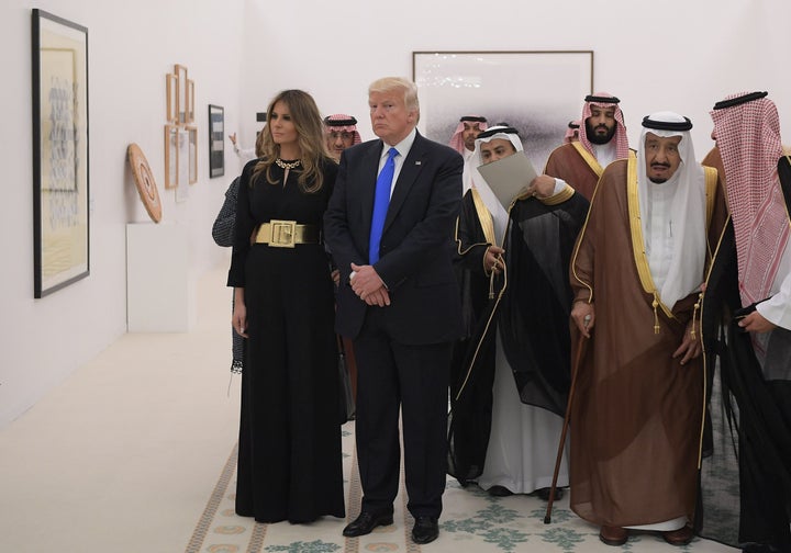 Saudi Arabia's King Salman bin Abdulaziz al-Saud, Donald Trump and Melania Trump look at a display of Saudi modern art at the Saudi Royal Court in Riyadh on May 20, 2017.