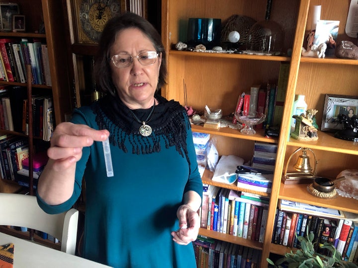 Barbara Trout, who has an asthma disorder, holds a vial of inhalation solution of Ipratropium Bromide and Albuterol Sulfate, prescribed medication at her home in Keizer, Ore., on Oct. 14, 2020. 