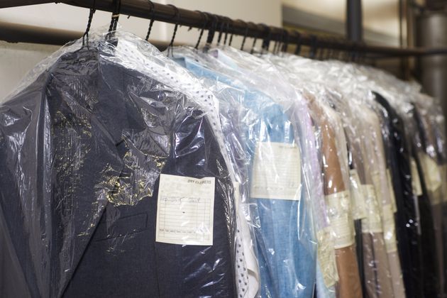 The chemicals used in dry cleaning don't kill viruses, but the heat applied during pressing and ironing can.